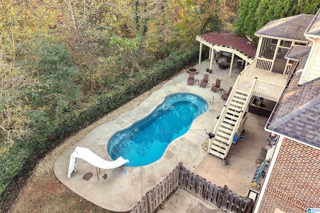 view of swimming pool with a patio area and a water slide