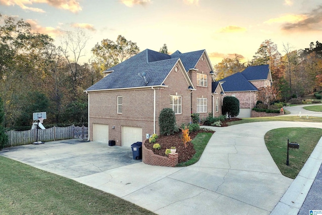 property exterior at dusk with a lawn and a garage