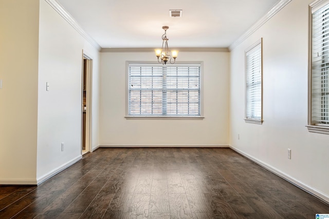 empty room featuring ornamental molding, dark wood-type flooring, and an inviting chandelier