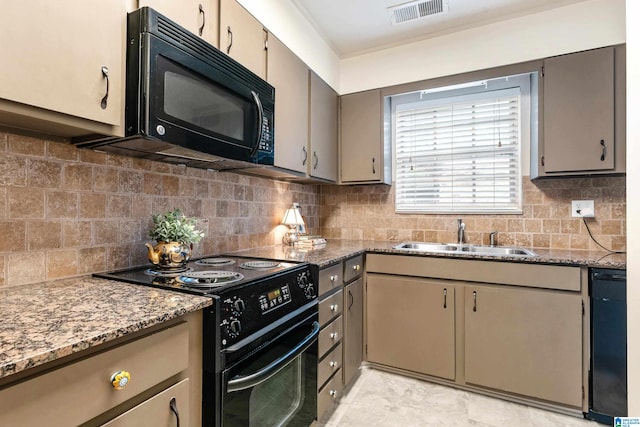 kitchen with black appliances, sink, dark stone counters, and tasteful backsplash