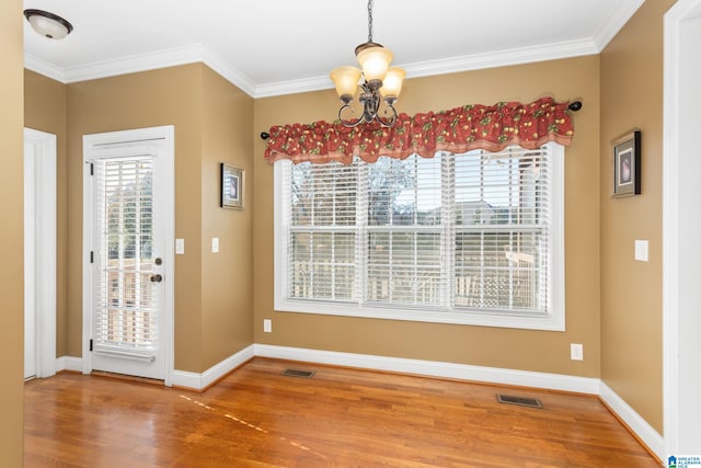175 Smithfield Ln, Springville, AL 35146 - unfurnished dining area featuring a chandelier, wood finished floors, crown molding, and baseboards
