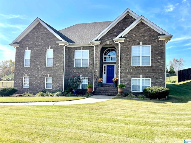 raised ranch featuring a front lawn