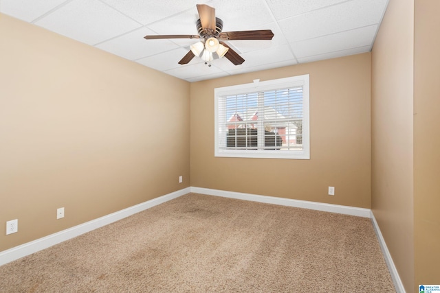 unfurnished room with a paneled ceiling, ceiling fan, and carpet floors