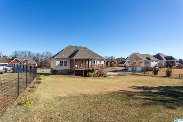 back of house with a wooden deck and a yard