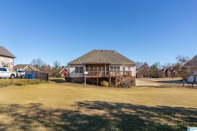 back of house featuring a lawn, a sunroom, and a deck