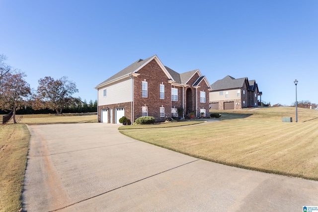 175 Smithfield Ln, Springville, AL 35146 - view of property exterior with brick siding, an attached garage, driveway, and a yard
