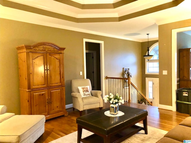 living room with wood-type flooring and ornamental molding