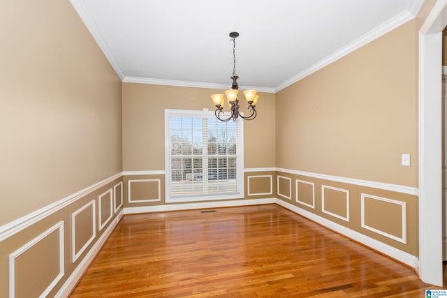175 Smithfield Ln, Springville, AL 35146 - empty room with a chandelier, crown molding, light wood finished floors, a wainscoted wall, and a decorative wall