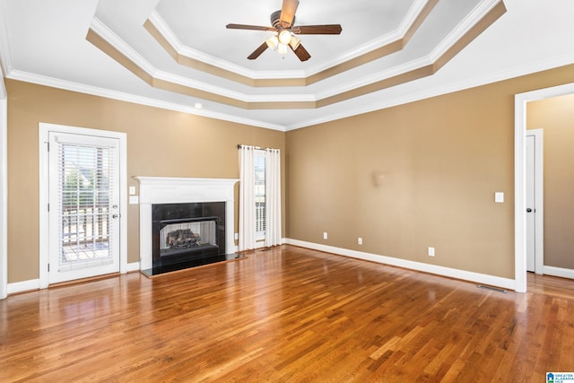 175 Smithfield Ln, Springville, AL 35146 - unfurnished living room with a raised ceiling, ceiling fan, wood finished floors, a high end fireplace, and ornamental molding