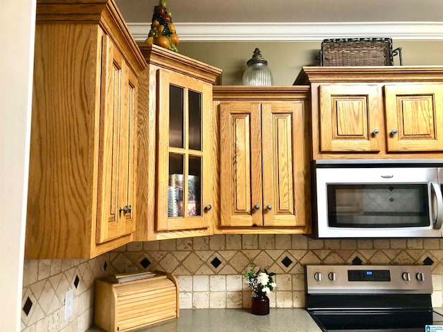 kitchen with decorative backsplash and appliances with stainless steel finishes