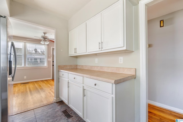 kitchen featuring white cabinetry, ceiling fan, wood-type flooring, and stainless steel refrigerator with ice dispenser