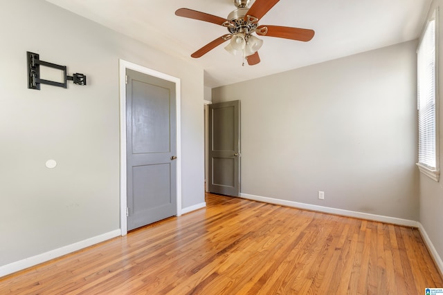 unfurnished bedroom with ceiling fan and light wood-type flooring