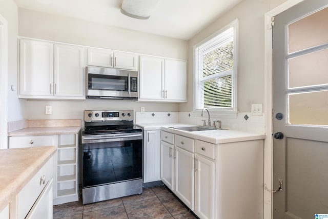 kitchen with white cabinetry, sink, and appliances with stainless steel finishes