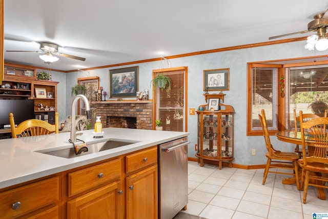 kitchen with ceiling fan, crown molding, sink, light tile patterned floors, and dishwasher