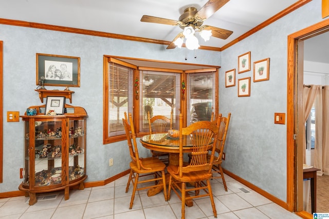 dining area with light tile patterned floors, ceiling fan, and ornamental molding