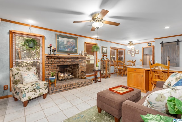 tiled living room featuring a barn door, crown molding, a fireplace, and ceiling fan