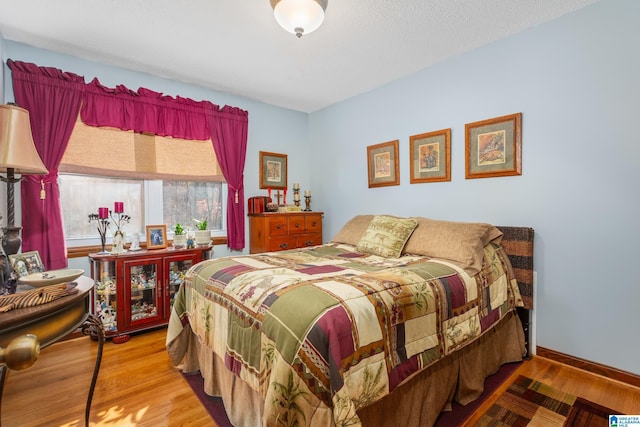 bedroom with hardwood / wood-style floors