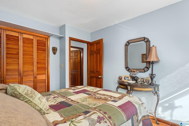 bedroom with a closet and a textured ceiling