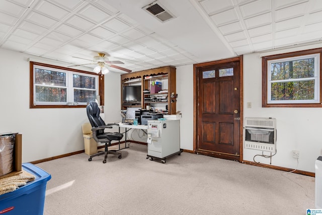 carpeted office with heating unit and ceiling fan