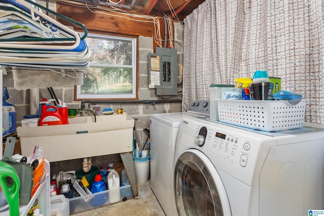 laundry room with washer and dryer, electric panel, and sink