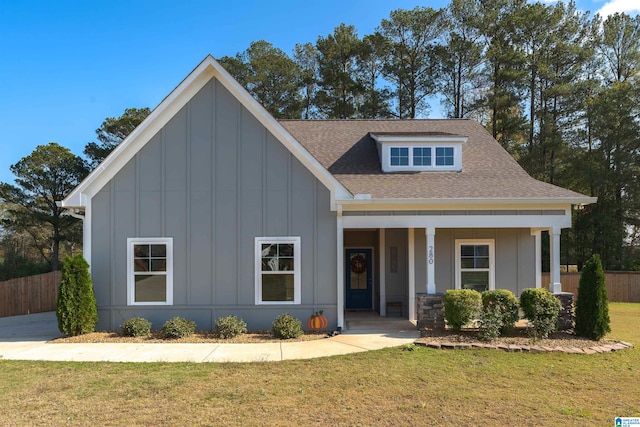 view of front of home with a front yard and a porch