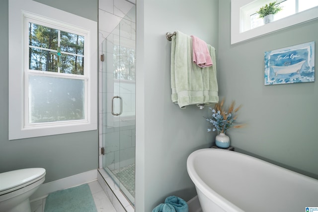 bathroom with tile patterned flooring, toilet, shower with separate bathtub, and a wealth of natural light