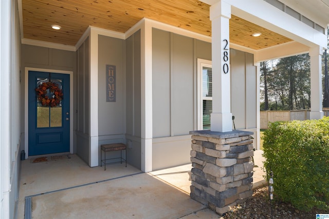 view of exterior entry featuring covered porch