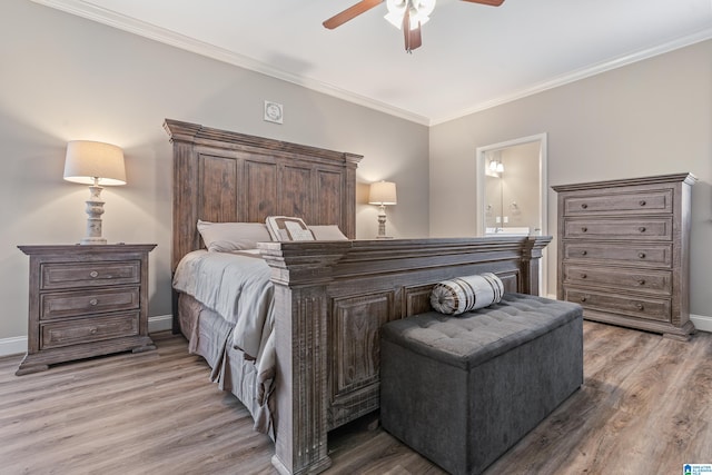 bedroom featuring ensuite bathroom, crown molding, ceiling fan, and light hardwood / wood-style floors