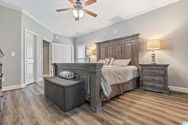 bedroom featuring ceiling fan, crown molding, and wood-type flooring