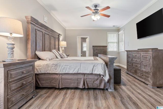 bedroom featuring hardwood / wood-style flooring, ceiling fan, and ornamental molding