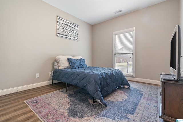 bedroom with dark wood-type flooring