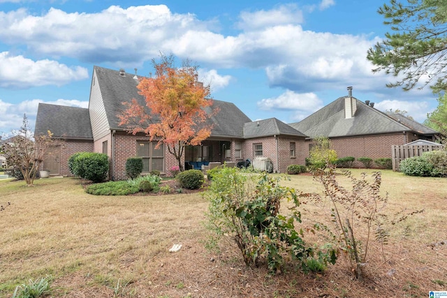 back of house featuring a yard