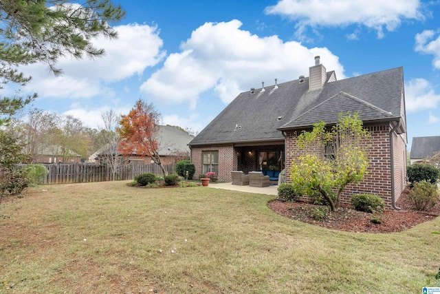 back of property with a lawn, an outdoor living space, and a patio