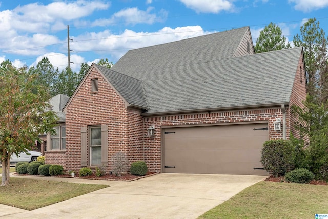 view of front of home with a garage and a front lawn