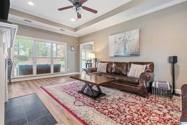 living room with ceiling fan, wood-type flooring, and ornamental molding