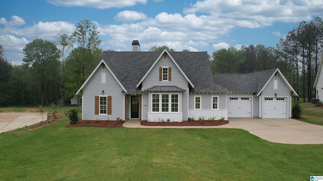 view of front of home featuring a front yard and a garage