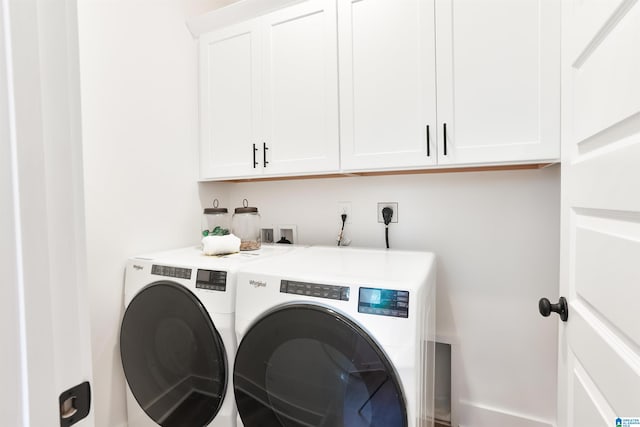 laundry room featuring cabinets and washer and dryer