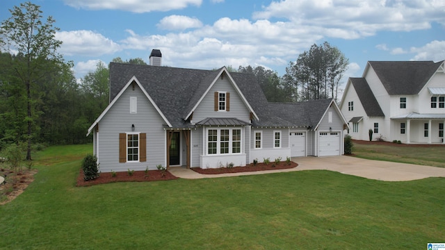 view of front of property featuring a front yard and a garage