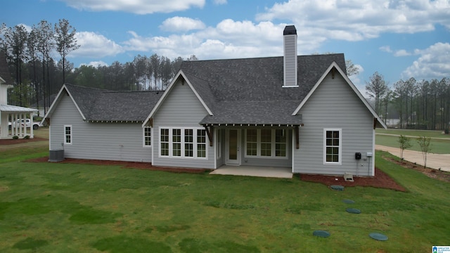 rear view of property featuring a yard, central AC unit, and a patio area