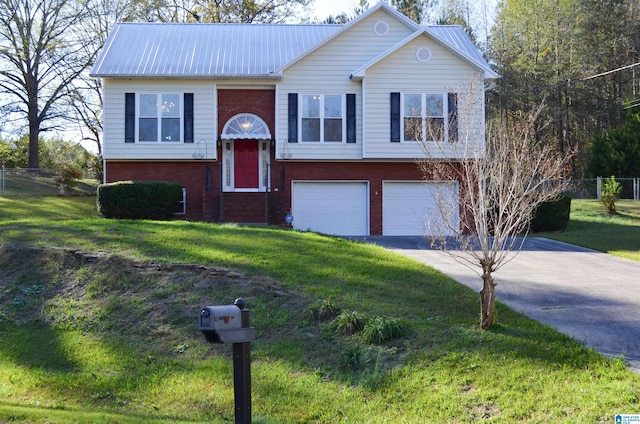 split foyer home featuring a garage and a front lawn