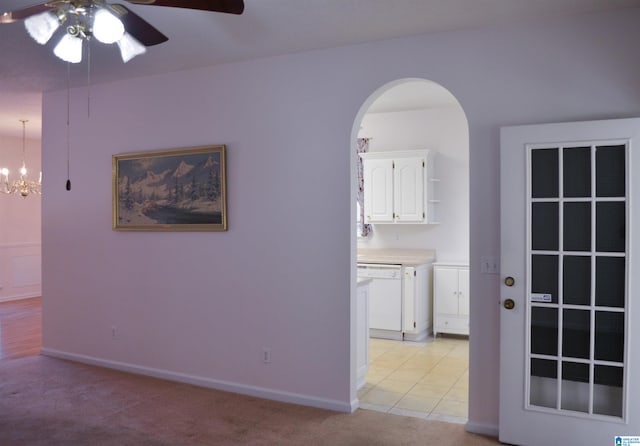 interior space featuring ceiling fan with notable chandelier