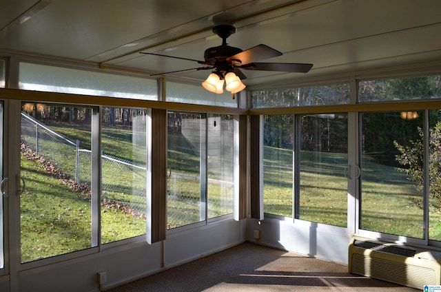 unfurnished sunroom with ceiling fan