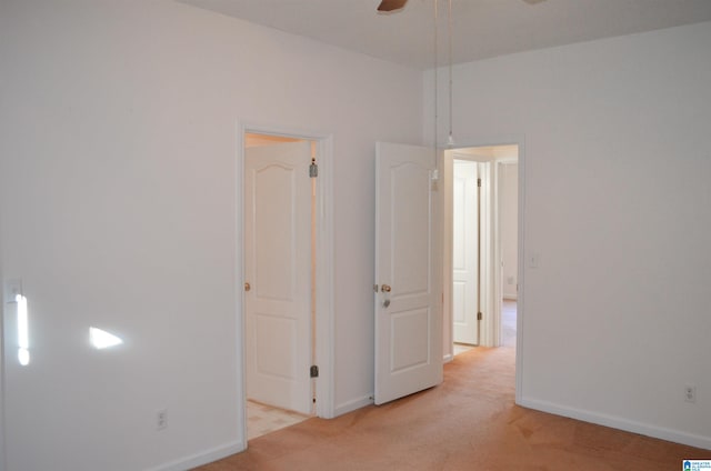 carpeted spare room with ceiling fan