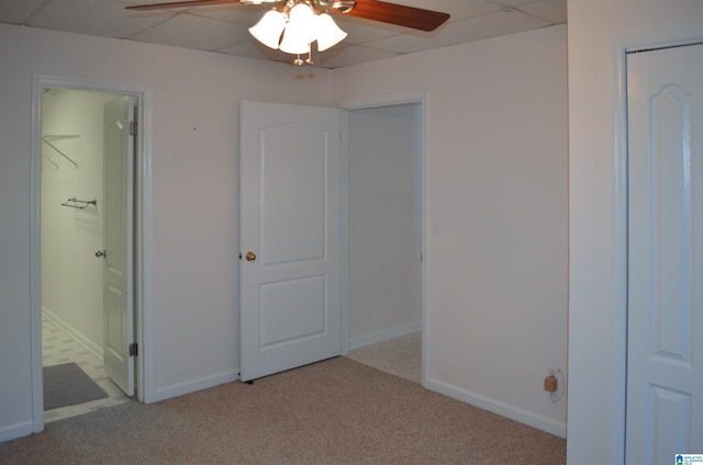 unfurnished bedroom featuring ceiling fan, light colored carpet, and ensuite bathroom