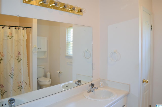 bathroom featuring vanity and toilet