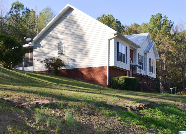 view of home's exterior featuring a yard