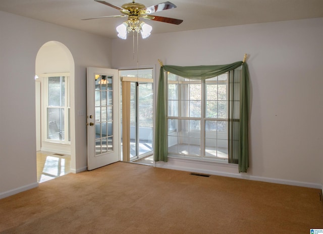 carpeted empty room featuring ceiling fan