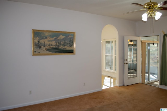 spare room featuring ceiling fan and carpet floors