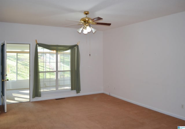 carpeted empty room featuring ceiling fan