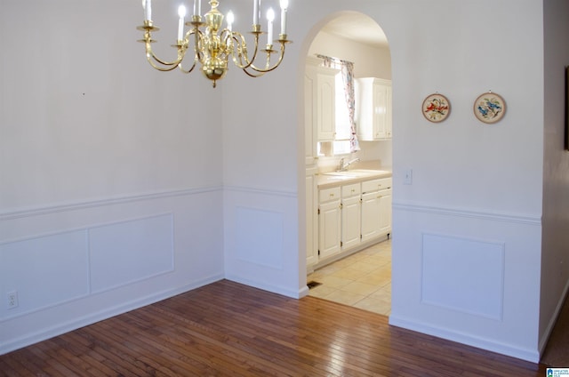 unfurnished dining area featuring sink and light wood-type flooring